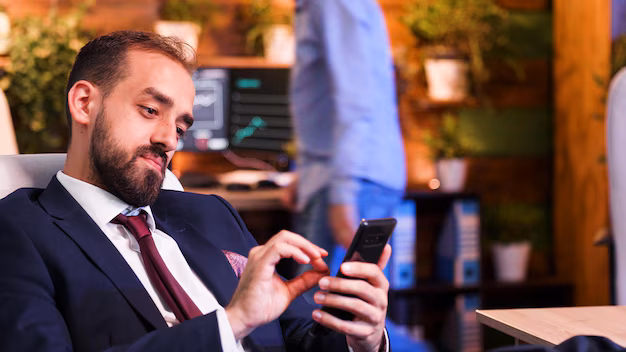 close-up-businessman-holding-phone-his-hand-modern-office_482257-32818